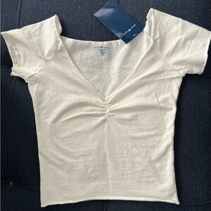 Brandy Melville white, stretchy fitted tee, a v-neck collar, rouched detailing